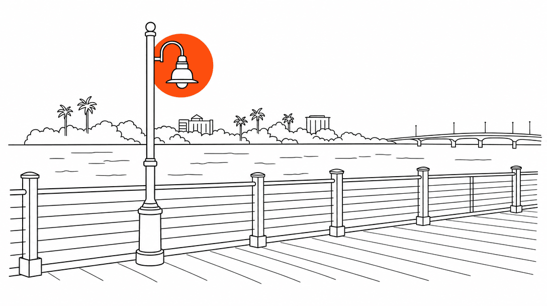 Flat line drawing of the Stuart Riverwalk boardwalk railing with the St. Lucie River implied behind it, one orange accent circle at the lamp post, white background, black lines.