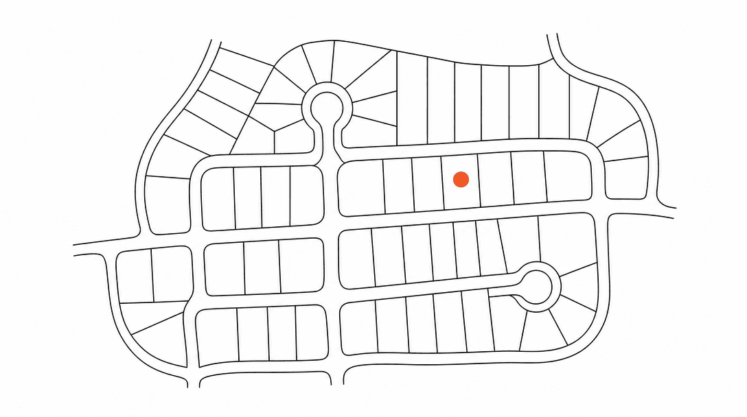 Flat line drawing of a new-subdivision street grid viewed from above, with one orange accent dot marking a specific lot on a white background with black lines.